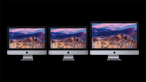 drei iMacs vor schwarzem Hintergrund