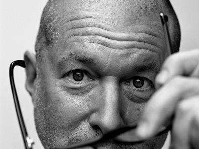 Portrait of Jonathan Ive taking of his glasses